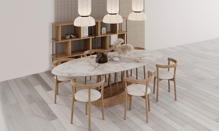 Photo d'ambiance d'une salle à manger avec deux bibliothèque, une table à manger et des chaises. La finition est en chêne avec des accents en inox bronze et de marbre blanc.